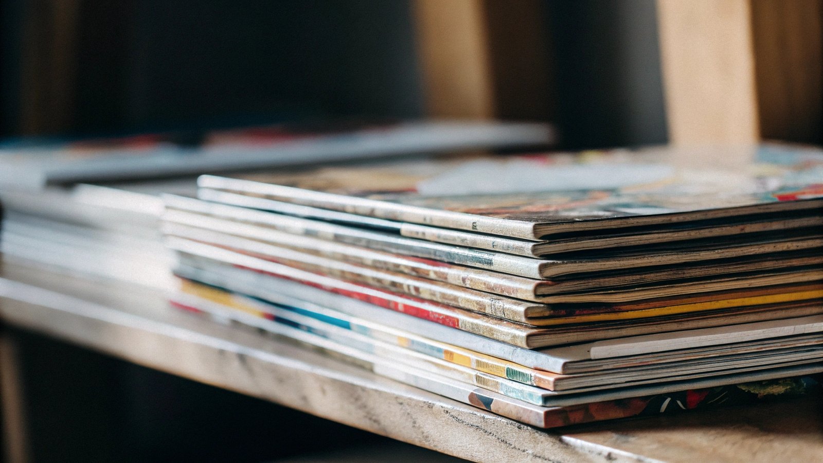 A colorful stack of children's books and art books, showing vibrant covers.
